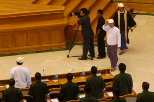 Myanmar's President Thein Sein waves to members of parliament after delivering his speech in Naypyitaw